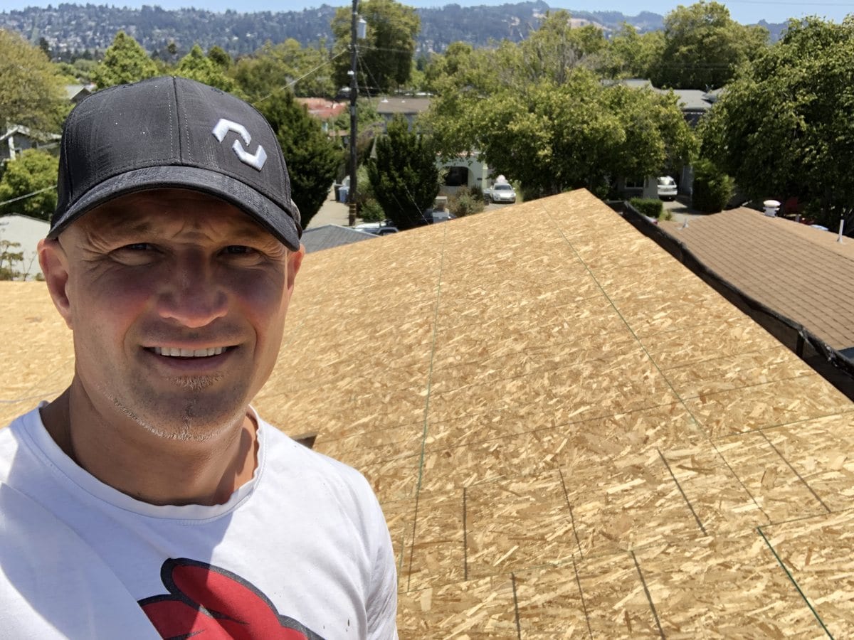 Mika Noori on the newly sheathed roof deck of a home he is building in the East Bay